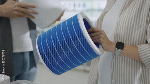 Unrecognizable man and woman in a consumer electronics store choosing a portable air purifying system and a quality HEPA filter for their home photo