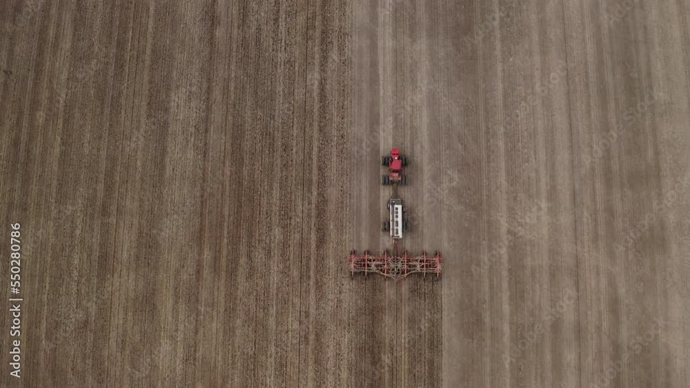 Wide angle bird's eye view of farmer seeding field, Saskatchewan, Canada. Wide angle bird's eye view of farmer seeding field, Saskatchewan, Canada.