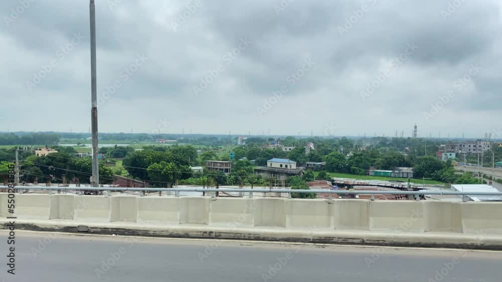 Cars driving on a flyover that goes above the city. Sylhet in 4k, 60 fps. Cars driving on a flyover that goes above the city. Sylhet in 4k, 60 fps.