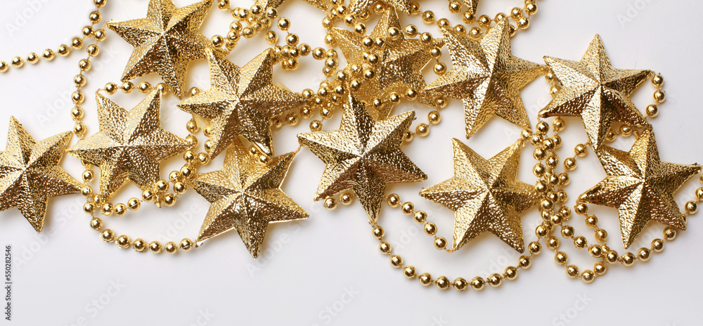 Gold star garland frame on light beige empty copy space horizontal background. Gold star garland frame on light beige empty copy space horizontal background.