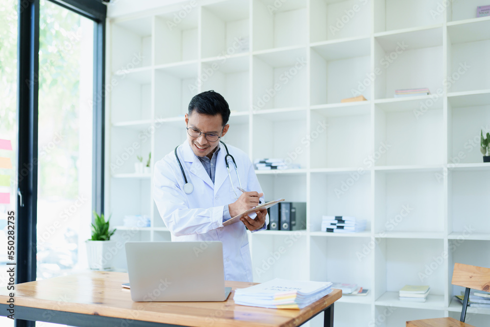 Portrait of a doctor looking at a patient's information before treating a disease Portrait of a doctor looking at a patient's information before treating a disease