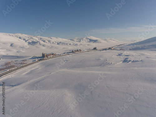 Aerial view of ski track and ski resort in the mountains