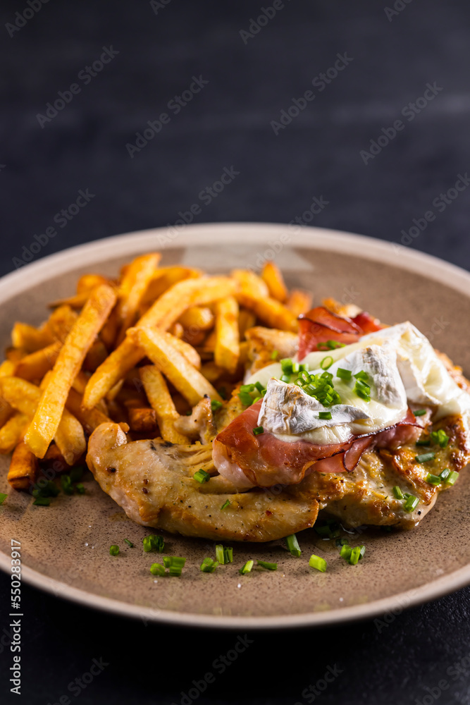 typical czech cuisine chicken slice baked with ham and camembert with french fries typical czech cuisine chicken slice baked with ham and camembert with french fries
