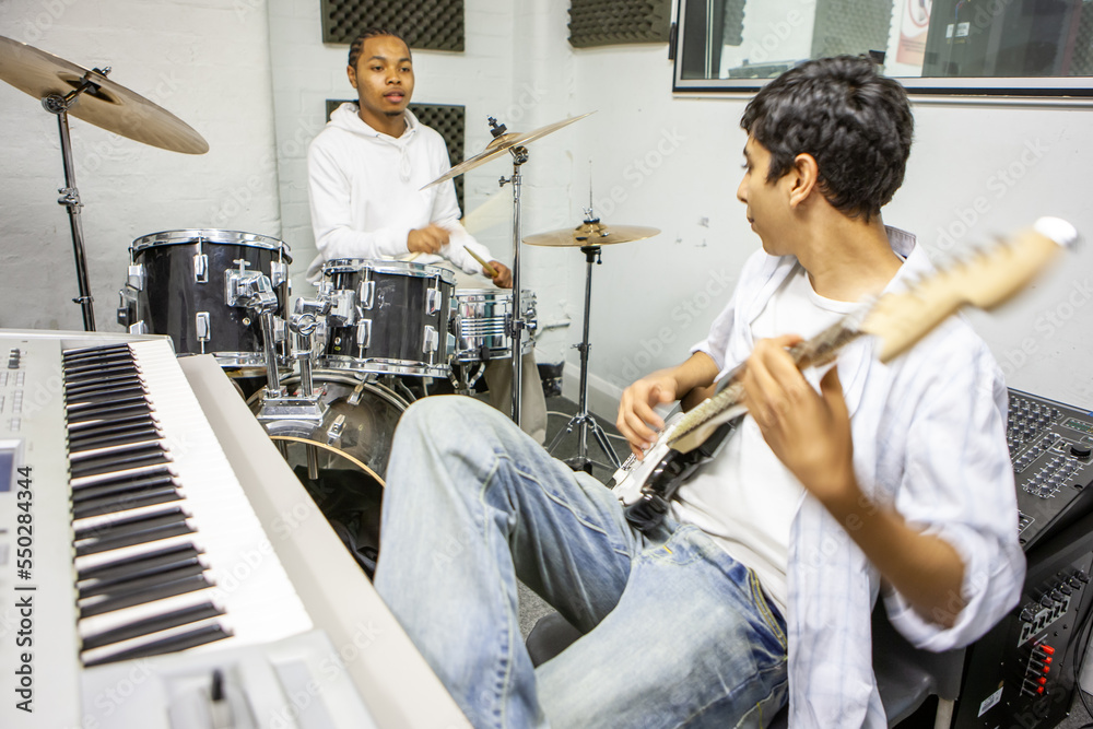 Music Students Jamming Session. A guitarist and drummer rehearsing