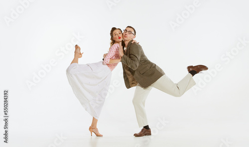 Billede på lærred Two emotional dancers in vintage style clothes dancing swing dance, rock-and-roll or lindy hop isolated on white background