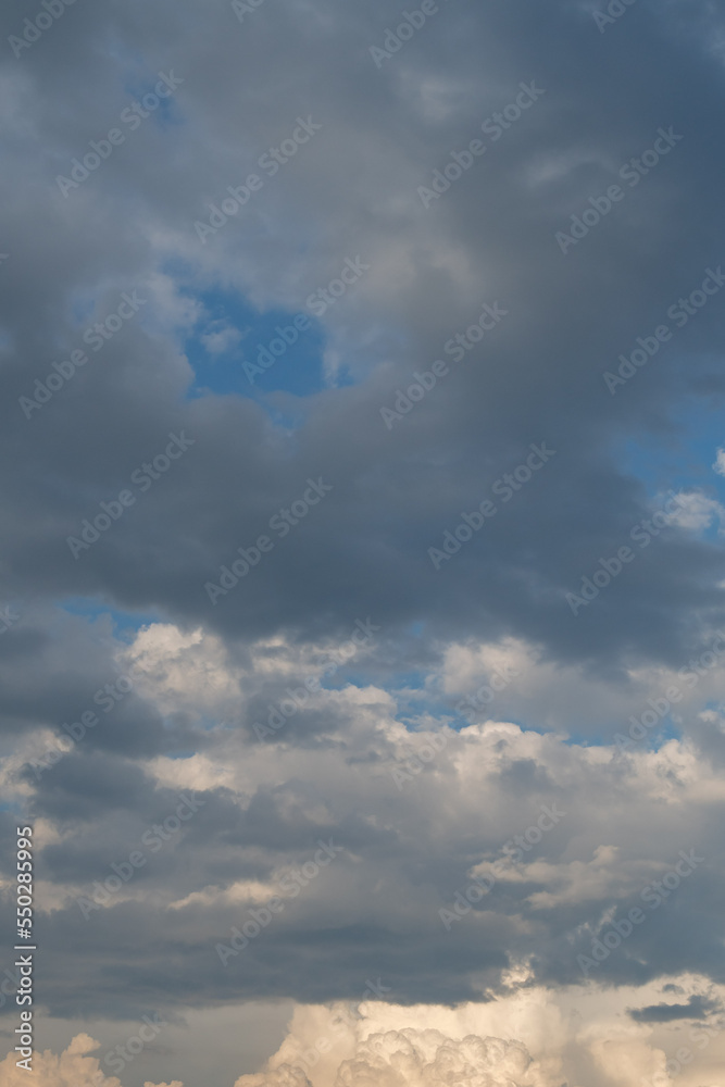 Mixed white and gray clouds on a blue sky in Minnesota, USA.
