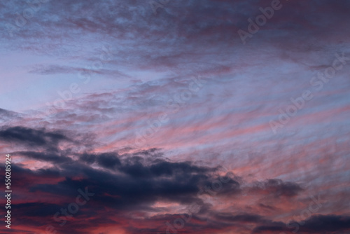 Pink and purple tinted clouds on blue sky at sunset in Minnesota. 