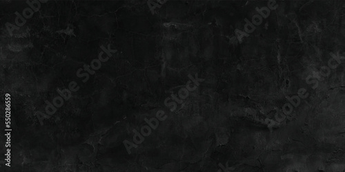 Old black background. Grunge texture. Dark wallpaper. Blackboard. Chalkboard. Wall