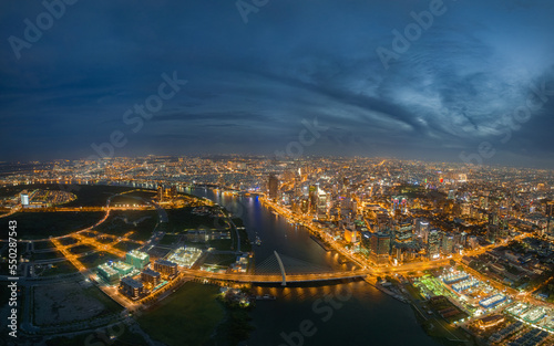 Top view aerial photo from flying drone of a Ho Chi Minh City with development buildings, transportation, energy power infrastructure. Financial and business centers in developed Vietnam. © Quang Ho