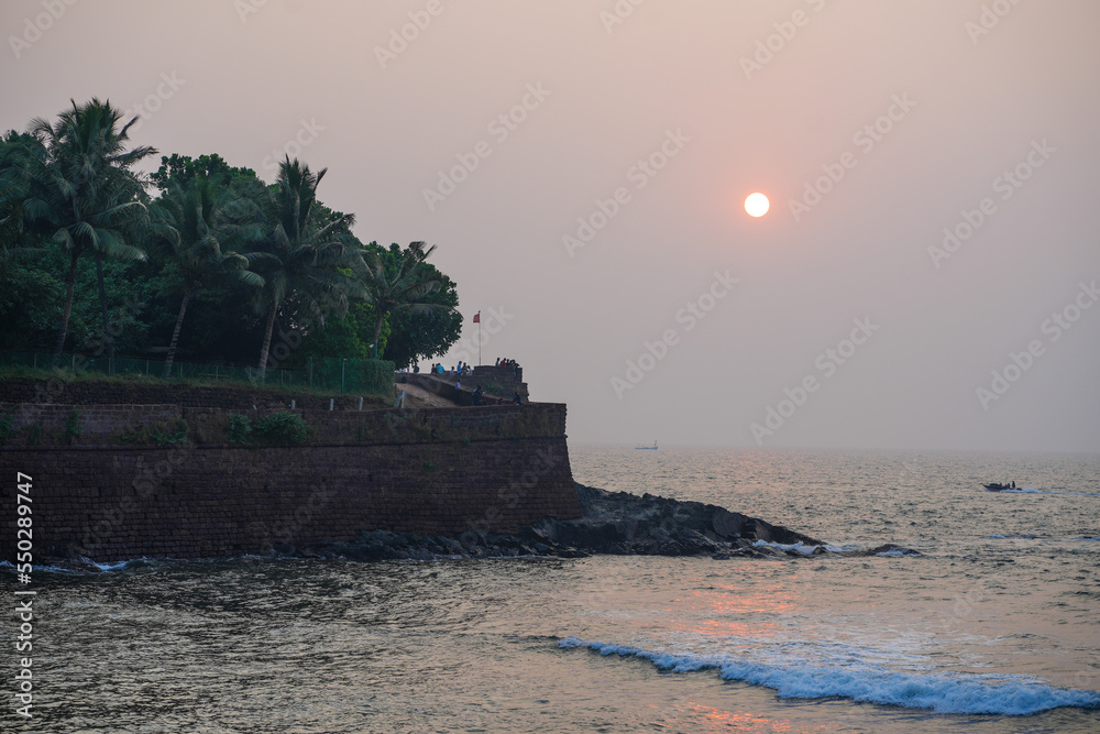 Sunset over the Aguada Fort in Goa captured from Sinquerim Beach