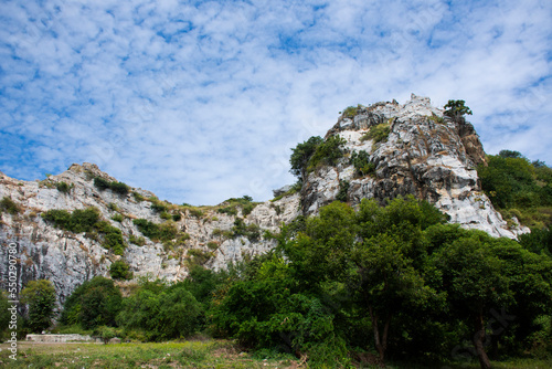 View landscape range is a series of small limestone mountains in Tham Khao Ngu stone rock park with cloud blue sky for thai people and foreign travelers travel visit rest relax in Ratchaburi, Thailand