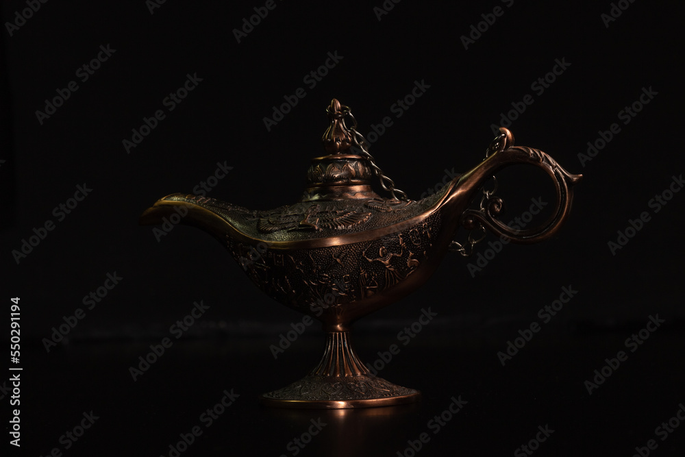 Aladdin's magic lamp isolated on black background Aladdin's magic lamp isolated on black background