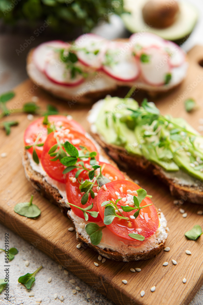 Different sandwiches with vegetables and microgreens