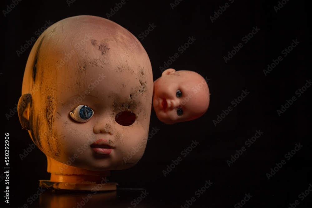 Damaged Dirty dubl Doll head on black background isolated Damaged Dirty dubl Doll head on black background isolated