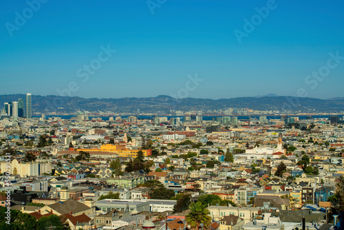 Sprawling cityscape with downtown city buildings and neighborhoods with houses in late afternoon sun in San Francisco California