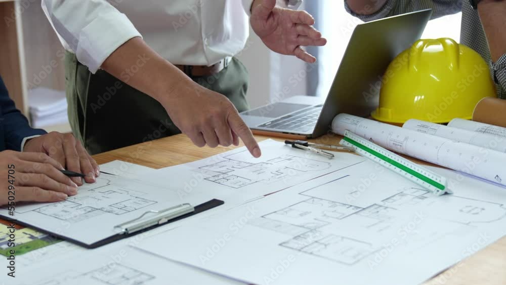 Businessman and architect meeting for planing and checking house design and house model and secretary takes notes, the architect design working drawing sketch plans blueprints