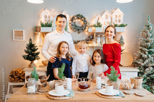 Beautiful big family in the kitchen with Christmas decor. to cook together.