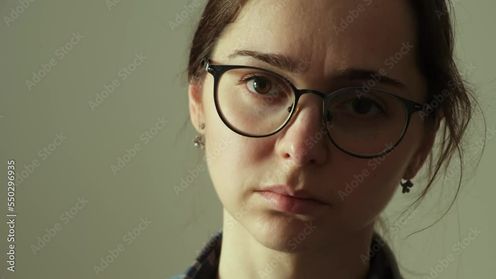 Young 30 year old woman portrait in a depressed tired state. Sad face close-up. Caucasian appearance. Painful condition. No makeup. Interbrow wrinkles. Closes eyes. Copy space. Unhappy look. Burnout. Young 30 year old woman portrait in a depressed tired state. Sad face close-up. Caucasian appearance. Painful condition. No makeup. Interbrow wrinkles. Closes eyes. Copy space. Unhappy look. Burnout.