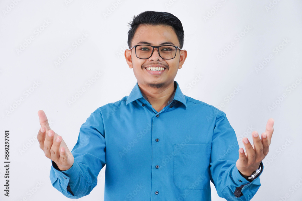 Smiling young asian businessman. with glasses in wearing blue shirt posing isolated on white background. Achievement career wealth business concept. Standing with outstretched hands Smiling young asian businessman. with glasses in wearing blue shirt posing isolated on white background. Achievement career wealth business concept. Standing with outstretched hands