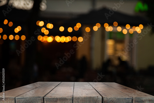 dark blurred background with empty table top, cafe restaurant windows. background for your product © Egor
