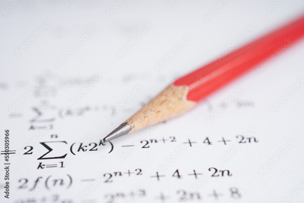 Pencil on mathematic formula exercise test paper in education school.