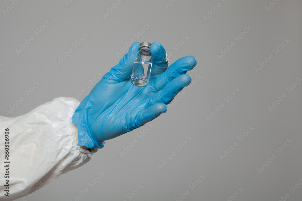Closeup of vial to vaccinate in doctor or nurse's hand for immunization. Vaccination concept. Closeup of vial to vaccinate in doctor or nurse's hand for immunization. Vaccination concept.