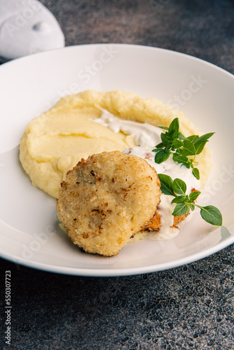 Fish cutlet with mashed potatoes and sauce