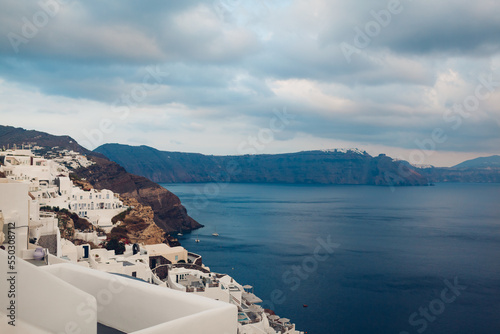 Santorini island Oia landscape. Traditional white houses on cliff with sea and mountains view. Travel to Greece.