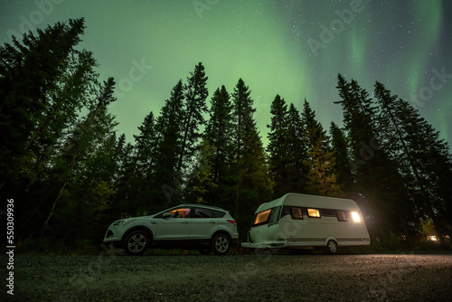Aurora shining over Camping Caravan in Swedish forest Tannforsen Waterfall Northern Lights color sky Sweden, Scandinavia © CL-Medien