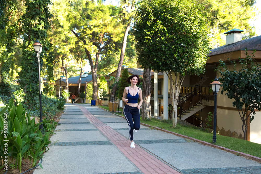 Morning jog near her country house, a woman goes in for sports.