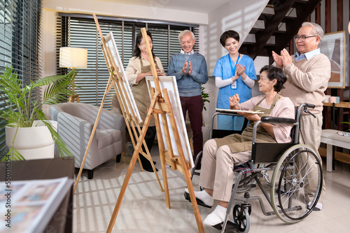 Group of Asian senior people are enjoy painting at elderly healthcare center, elder group therapy concept.