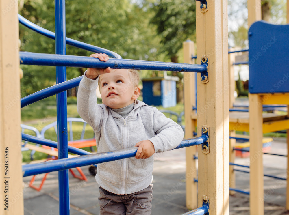 little boy playing on the playground outdoors little boy playing on the playground outdoors