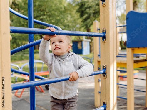 little boy playing on the playground outdoors © andriyyavor