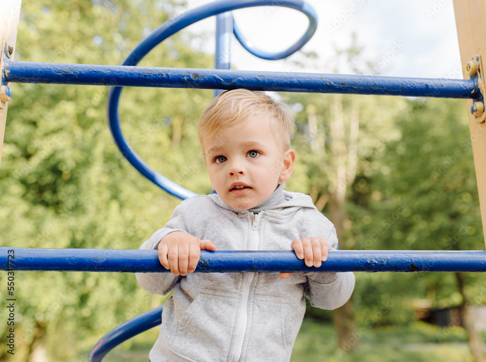 little boy playing on the playground outdoors little boy playing on the playground outdoors