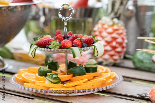 high-grade glassware with fresh fruit, double bowl with fresh fruit,  double bowl with strawberries and orange, sweet door