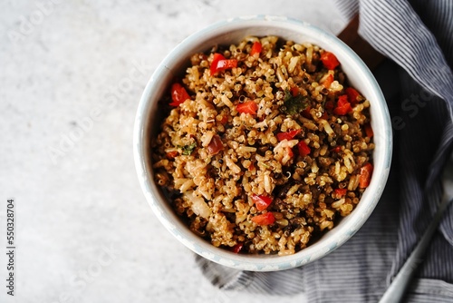 Quinoa brown rice pulao with red pepper served in a bowl- healthy eating concept