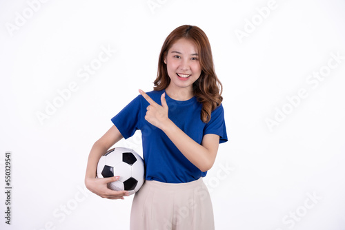 Asian woman smiling in blue t-shirt holding football to cheering the soccer game isolated on white screen background. © Parichat