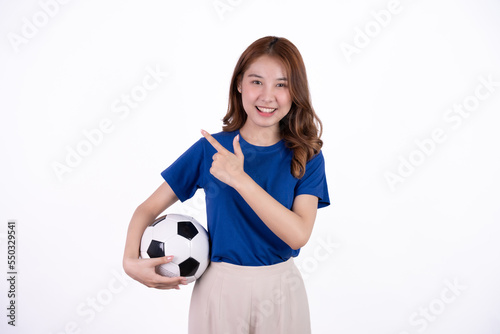 Asian woman smiling in blue t-shirt holding football to cheering the soccer game isolated on white screen background.