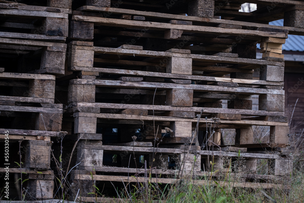 stacked old wooden palettes. Wooden industrial background