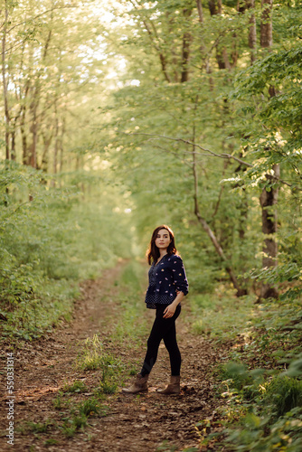 A beautiful young woman walking in the forest