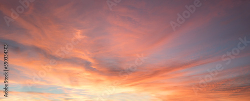 romantic colorful wide sunset sky orange and blue with beautiful clouds