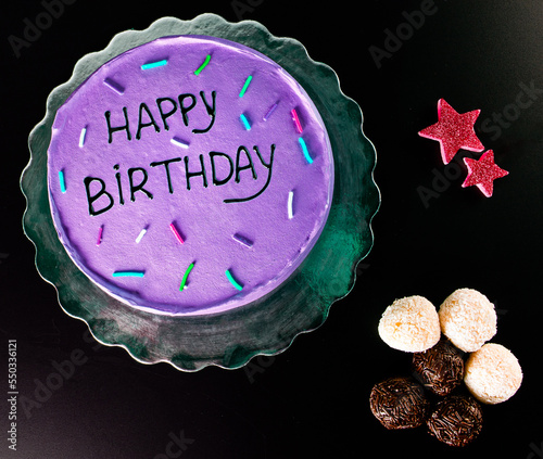 purple birthday cake with black background