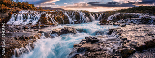 Wonderful nature of Iceland. Classic long exposure view of famous waterfall. Typical Icelandic scenery during sunset. Picture of wild area. Dramatic Scene with colorful sky. Iceland