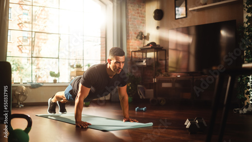 Strong Athletic Black Man Does Workout at Home Gym, Doing Push Ups. Lean Fit Muscular Mixed Race Sportsman Staying Healthy, Training at Home. Sweat and Determination. Wide Shot