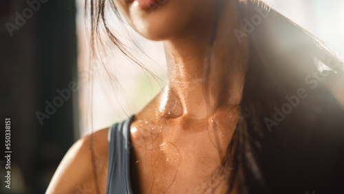 Close up Shot of a Young Adult woman's neck Sweating After Heavy Workout at Home. Successful Empowered Woman Fighting and Winning fight Against Injustices, Prejudices. photo