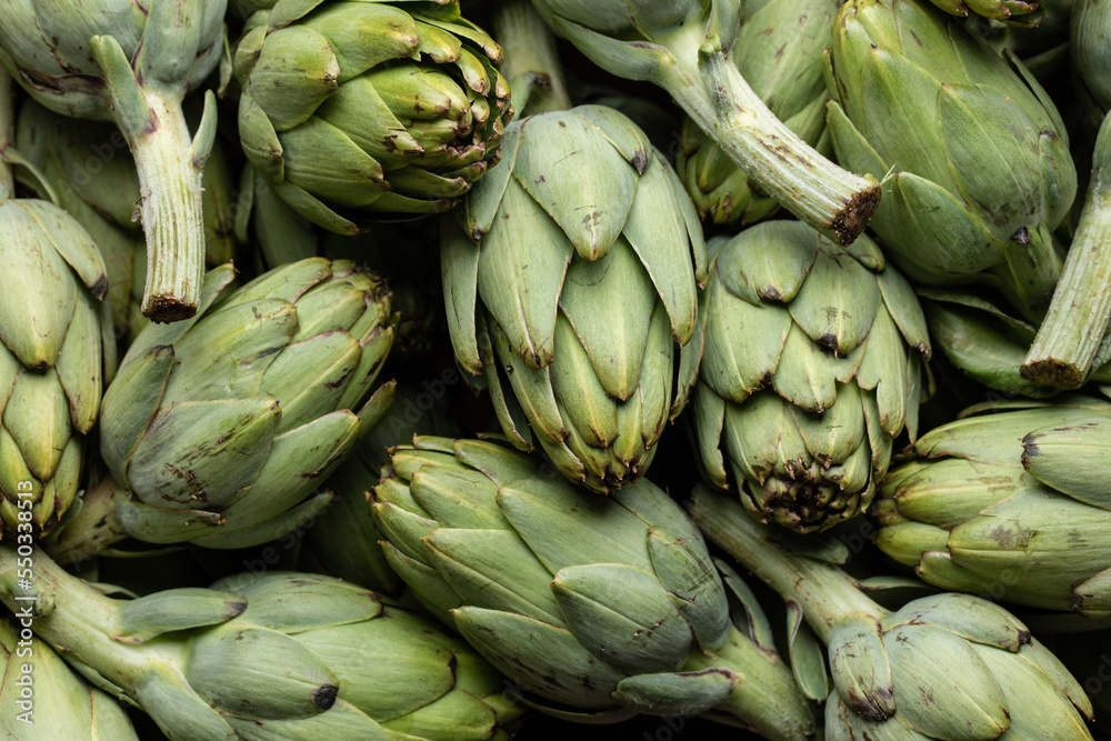 Collection of fresh artichokes in market Collection of fresh artichokes in market