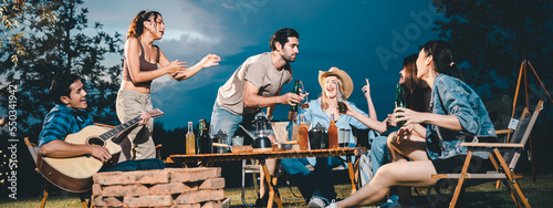 Photography Young hipster people having fun to music dining and drinking together in campsit
