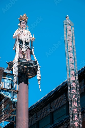 Vertical shot of a statue of a goddess in the historic Baipu Temple in Beijing, China photo