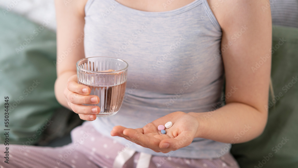 Woman holding pill in hand with water.Health concept Woman holding pill in hand with water.Health concept