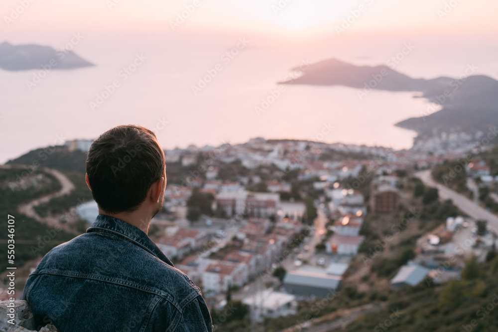 A young man meets on a mountain by the sea meets the sunset. A young man meets on a mountain by the sea meets the sunset.